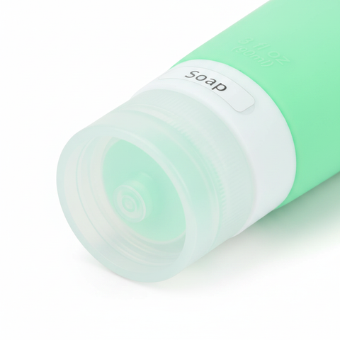 Close-up of clear bottom cap with soap label window on mint green silicone travel squeeze bottle