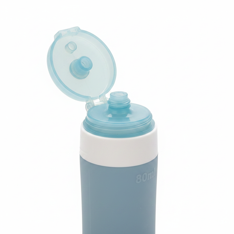 Close-up of silicone travel bottle flip lid detail on white background