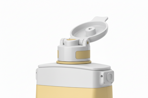 Close-up of white flip-top sport nozzle cap on golden yellow collapsible silicone water bottle
