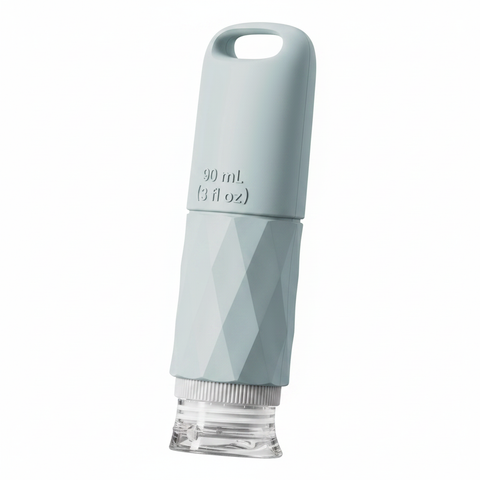 Grey-blue 90ml silicone travel bottle at 45 degree angle showing loop handle and clear bottom cap on white background