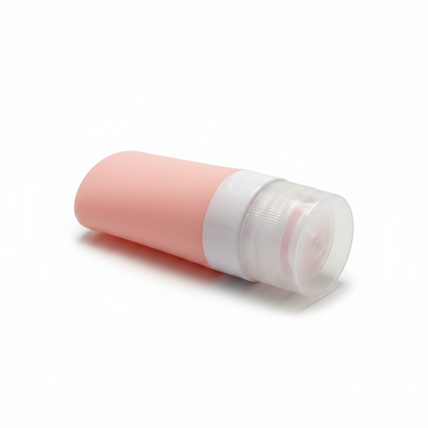 Pink silicone travel bottle side angle view on white background