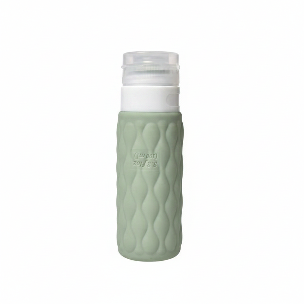 Sage green diamond textured silicone travel cosmetic bottle with white pump cap upright on pure white background – main product image