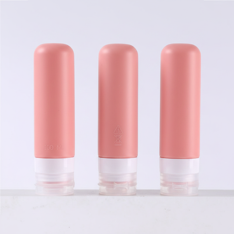 Three dusty rose pink silicone travel bottles 100ml showing front side and back angles on white background